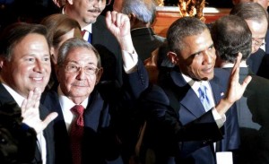 Cuba's President Raul Castro (C) holds up his left fist as his Panamanean and U.S. counterparts Juan Carlos Varela (L) and Barack Obama (R) wave before the inauguration of the VII Summit of the Americas in Panama City April 10, 2015, in this handout photo provided by the Presidency of Cuba. Picture taken April 10, 2015. REUTERS/Presidency of Cuba/Handout via Reuters   TPX IMAGES OF THE DAY     ATTENTION EDITORS - THIS PICTURE WAS PROVIDED BY A THIRD PARTY. REUTERS IS UNABLE TO INDEPENDENTLY VERIFY THE AUTHENTICITY, CONTENT, LOCATION OR DATE OF THIS IMAGE. FOR EDITORIAL USE ONLY. NOT FOR SALE FOR MARKETING OR ADVERTISING CAMPAIGNS. THIS PICTURE WAS PROCESSED BY REUTERS TO ENHANCE QUALITY. AN UNPROCESSED VERSION HAS BEEN PROVIDED SEPARATELY.